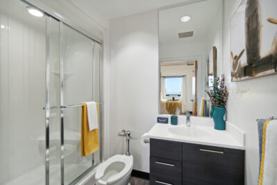 Bathroom with a walk in shower and large mirror