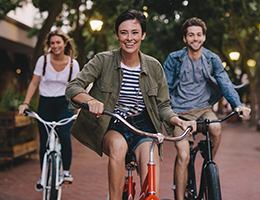 a group of young adults riding bicycles