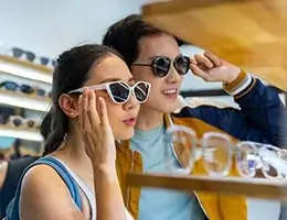 young adults trying on sunglasses