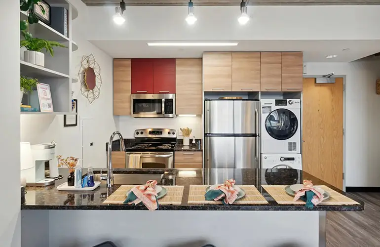 Kitchen with laundry machine and dryer