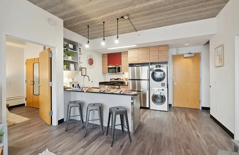 Kitchen with laundry machine and dryer